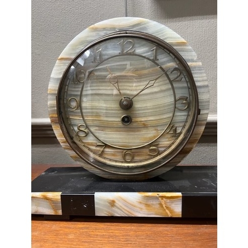 286 - An Art Deco marble clock garniture, the circular dial with Arabic numerals, the plinth surmounted wi... 