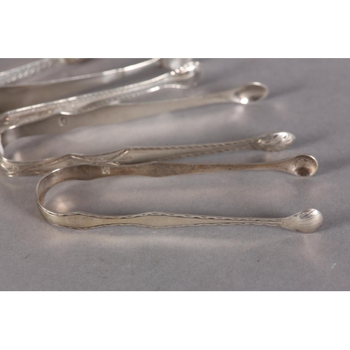 281 - A PAIR OF SCOTTISH SILVER BRIGHT CUT SUGAR TONGS c.1790 together with three other pairs of silver to... 