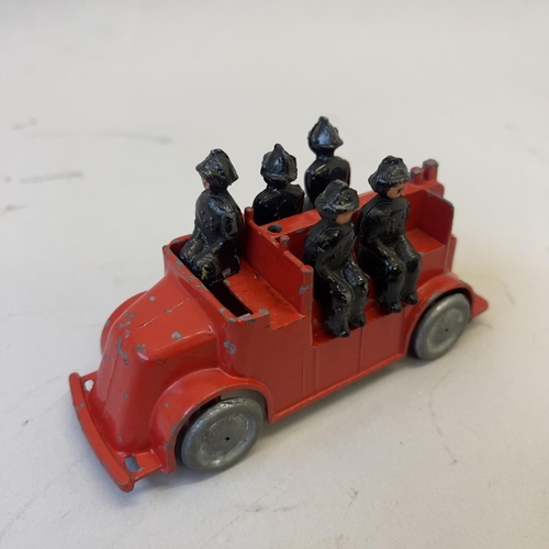 100 - A collection of four die cast models from, including a Betal Fire Truck complete with five firemen, ... 