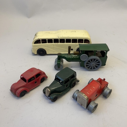 105 - A collection of four Triang Minic clockwork vehicles, including two saloon cars, a tractor (missing ... 