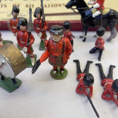 108 - A collection of Britains lead soldiers, including the Grenadiers, the Scots Guards and two beefeater... 