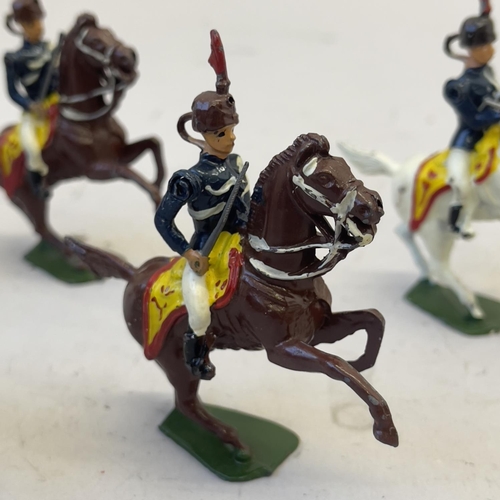 109 - A collection of five mounted soldiers on horseback.