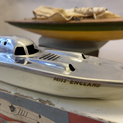 115 - A model speedboat ‘Miss England’ with a methylated spirits engine, boxed, along with an Ailsa Pond Y... 