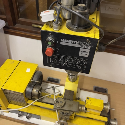 133 - A Hobbymat lathe and pillar drill, along with a box of tools and accessories.