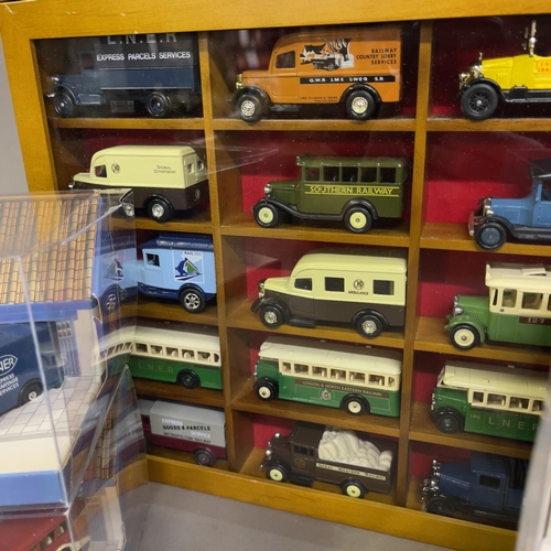 52 - A collection of 42 Oxford Die Cast and Days Gone die cast buses, trucks and vans, 15 in wooden displ... 