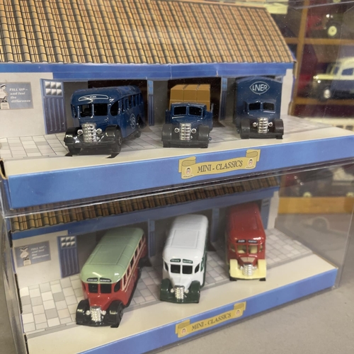 52 - A collection of 42 Oxford Die Cast and Days Gone die cast buses, trucks and vans, 15 in wooden displ... 