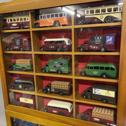 52 - A collection of 42 Oxford Die Cast and Days Gone die cast buses, trucks and vans, 15 in wooden displ... 