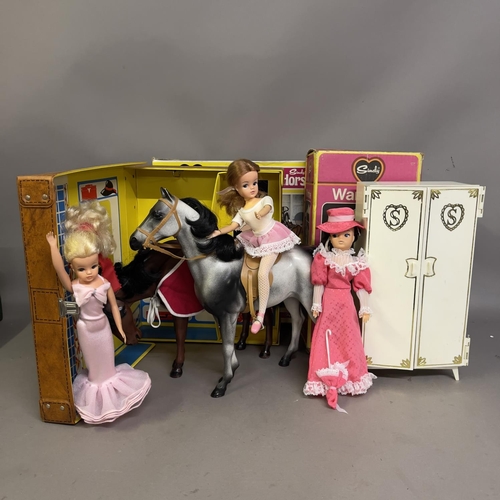 82 - A Sindy Horse (boxed), three Sindy Dolls, a Sindy Wardrobe (boxed), a Sindy Apartment Carry Case and... 