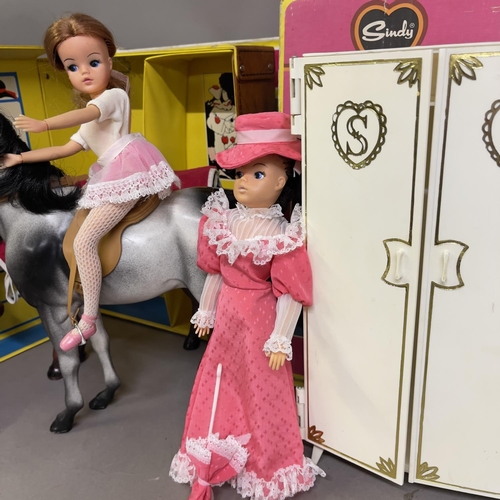 82 - A Sindy Horse (boxed), three Sindy Dolls, a Sindy Wardrobe (boxed), a Sindy Apartment Carry Case and... 