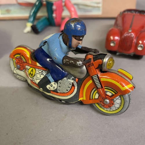 85 - An AM Metta Russian tin plate clockwork motorcycle racer, a Schuco Kommando Anno 2000 clockwork car ... 