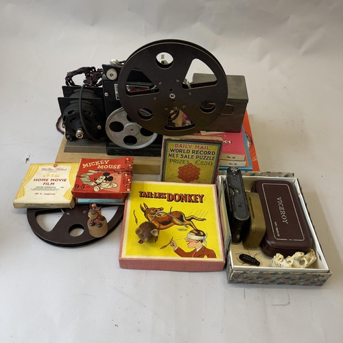 93 - A Pathescope 9.5mm projector, a selection of 9.5mm films including Mickey Mouse, a Vest Pocket Camer... 