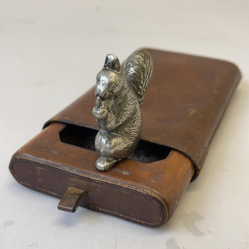 94 - A motorcycle mascot in the shape of a squirrel tightly holding its nuts, approximately 5cm tall, alo... 