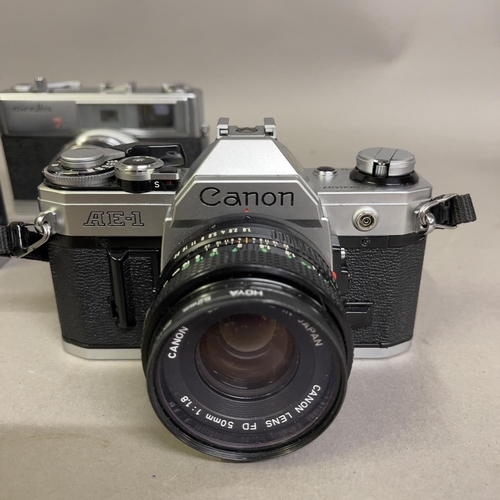 31 - A Canon AE-1 with 50mm F1.8 lens, a Canon FTb with 50mm F1.8 lens and a Minolta Hi-Matic 7S with 45m... 