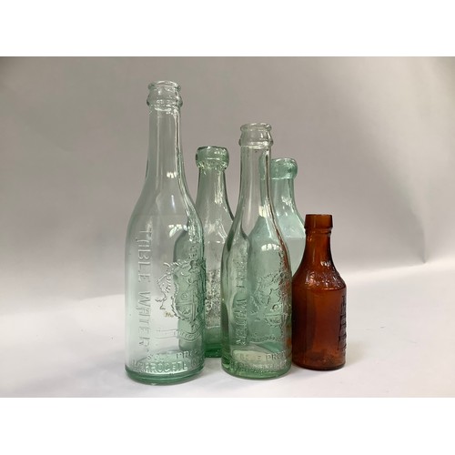 279 - Harrogate Spa Table Water glass bottle with crest in shield, another smaller together with two other... 