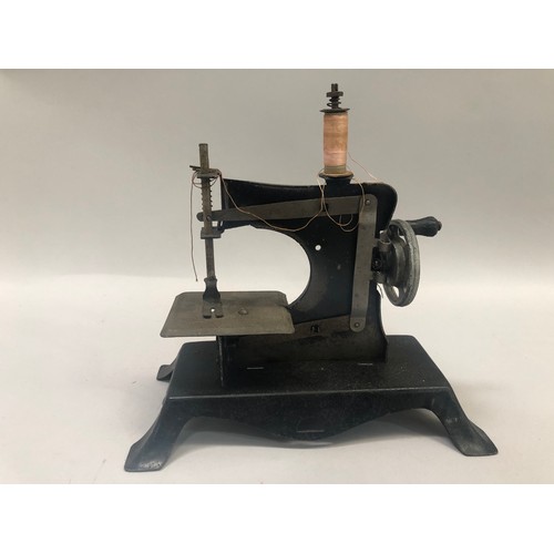 87 - A Victorian tin plate toy sewing machine