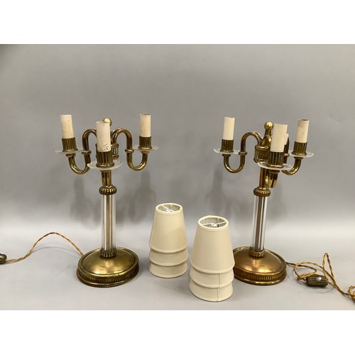 12 - A PAIR OF CONTINENTAL ART DECO AND BRASS GLASS THREE LIGHT TABLE LAMPS, the serpentine arms with ree... 