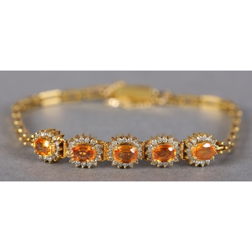 186 - A YELLOW SAPPHIRE AND DIAMOND BRACELET, the oval faceted sapphires claw set, raised against a surrou... 