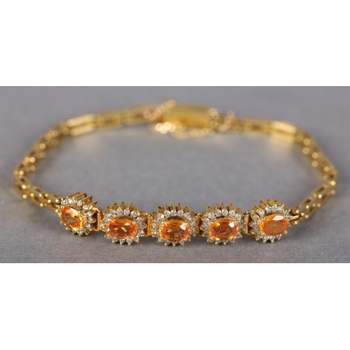 186 - A YELLOW SAPPHIRE AND DIAMOND BRACELET, the oval faceted sapphires claw set, raised against a surrou... 