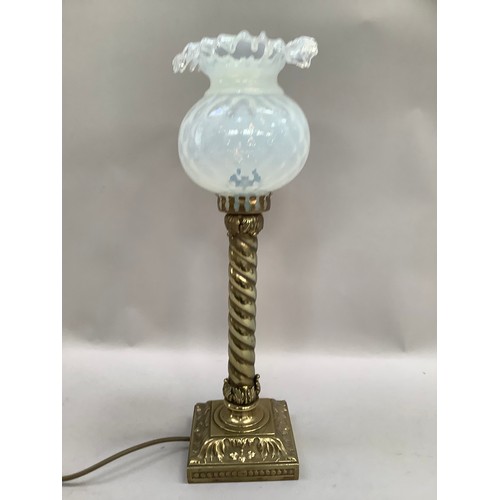 31 - A VICTORIAN BRASS STYLE TABLE LAMP having a leaf capped wrythen column on a leaf cast base of square... 