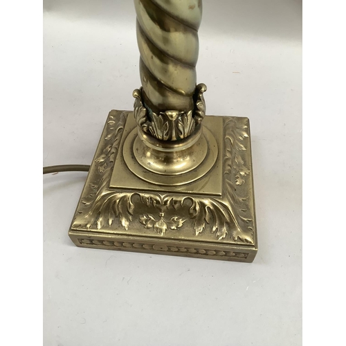 31 - A VICTORIAN BRASS STYLE TABLE LAMP having a leaf capped wrythen column on a leaf cast base of square... 