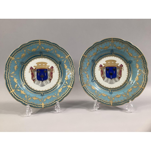 107 - A PAIR 19TH CENTURY SEVRES PORCELAIN CABINET PLATES central armorial motif, bordered with blue celes... 