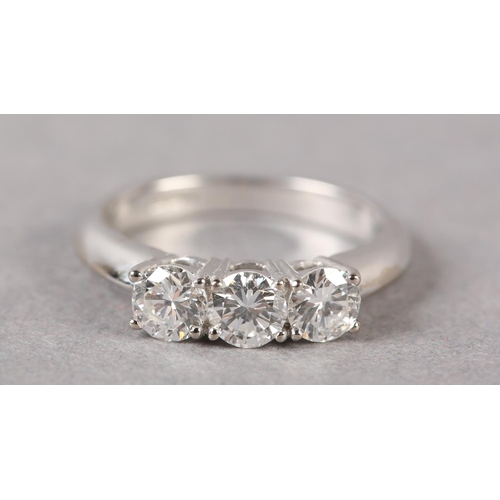 172 - A THREE STONE DIAMOND RING in 18ct white gold, the brilliant cut stones claw set in line, approximat... 