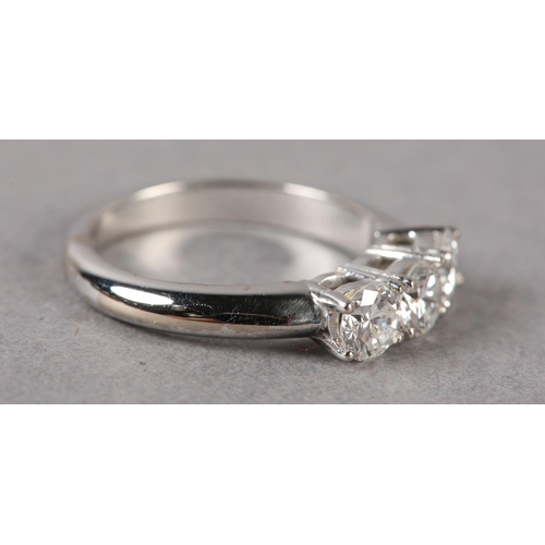 172 - A THREE STONE DIAMOND RING in 18ct white gold, the brilliant cut stones claw set in line, approximat... 