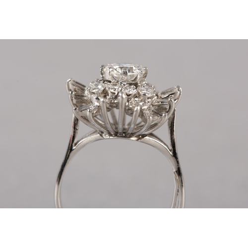 183 - A DIAMOND CLUSTER RING, the principal brilliant cut stone claw set and raised against undulating tie... 