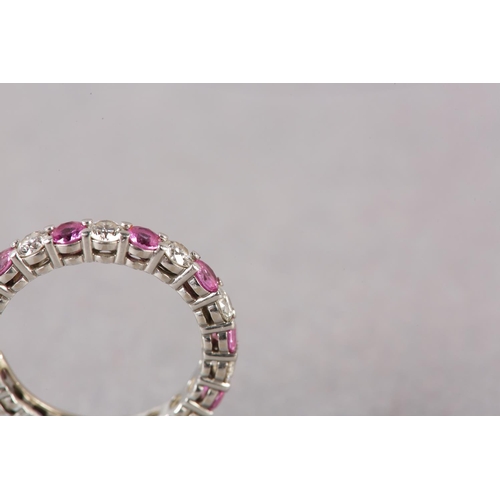 177 - A RUBY AND DIAMOND ETERNITY RING BY TIFFANY AND CO in platinum, the circular faceted rubies and bril... 