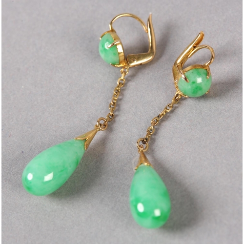 179 - A PAIR OF JADE EAR PENDANTS C1950, in 14ct gold, each set with a pear shaped jade drop hung on a tra... 