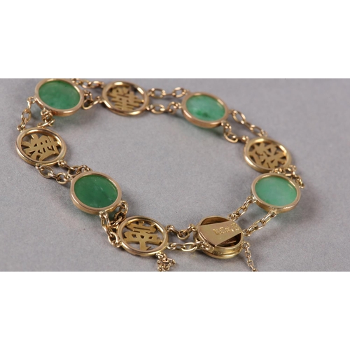 180 - A JADE BRACELET C1950 in 14ct gold, the circular cabochon stones collet set alternating with pierced... 