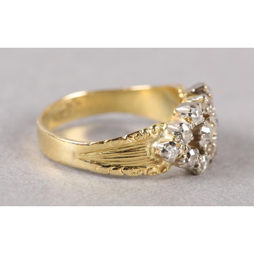 189 - A VICTORIAN DIAMOND CLUSTER RING in 18ct gold, the old European cut stones claw set within a pierced... 