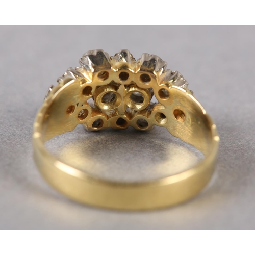 189 - A VICTORIAN DIAMOND CLUSTER RING in 18ct gold, the old European cut stones claw set within a pierced... 