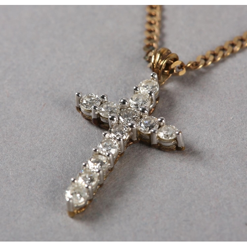 190 - A DIAMOND SET CROSS in 9ct gold, the brilliant cut stones claw set, hung from a faceted curb link ch... 