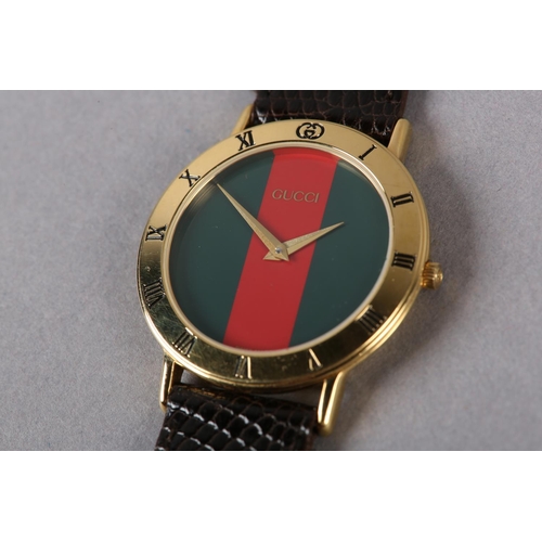 266 - A GUCCI QUARTZ WRISTWATCH, c1995, in rolled gold case no 0445654, burgundy and green striped sans he... 