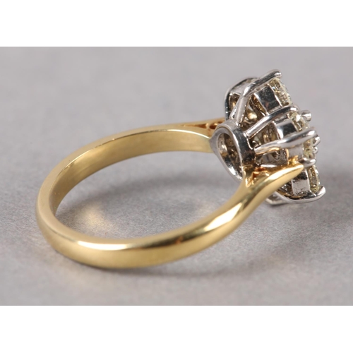 198 - A DIAMOND CLUSTER RING in 18ct yellow and white gold, the brilliant cut stones claw set within a cir... 