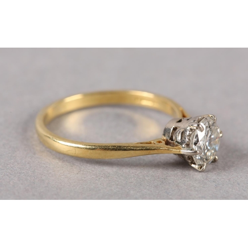 200 - A SINGLE STONE DIAMOND RING in 18ct yellow and white gold, the brilliant cut stone crown set flanked... 