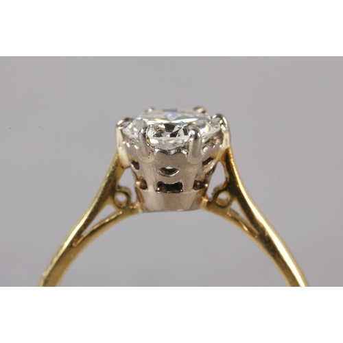 200 - A SINGLE STONE DIAMOND RING in 18ct yellow and white gold, the brilliant cut stone crown set flanked... 