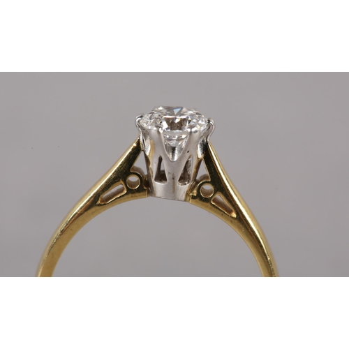 201 - A SINGLE STONE DIAMOND RING in 18ct yellow and white gold, the brilliant cut stone crown set, flanke... 