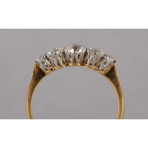 202 - A FIVE STONE DIAMOND RING C1950 in 18ct gold and platinum, the graduated transitional brilliant cut ... 