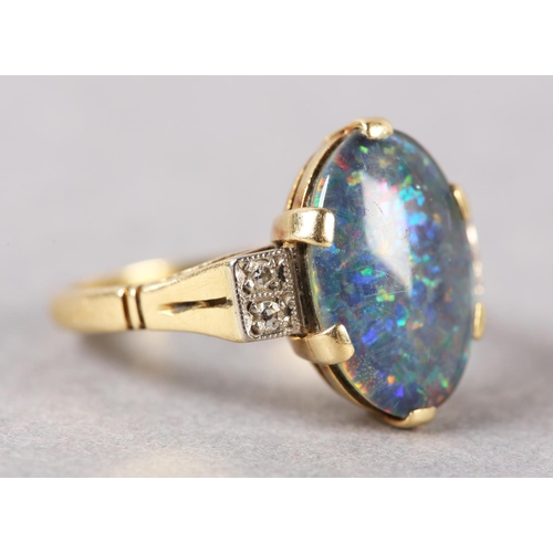 206 - AN BLACK OPAL DOUBLET AND DIAMOND RING C1950 in 18ct gold, the oval cabochon stone claw set flanked ... 