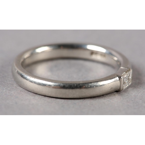 207 - A SINGLE STONE DIAMOND RING in platinum channel set with a baguette cut stone, approximate weight of... 