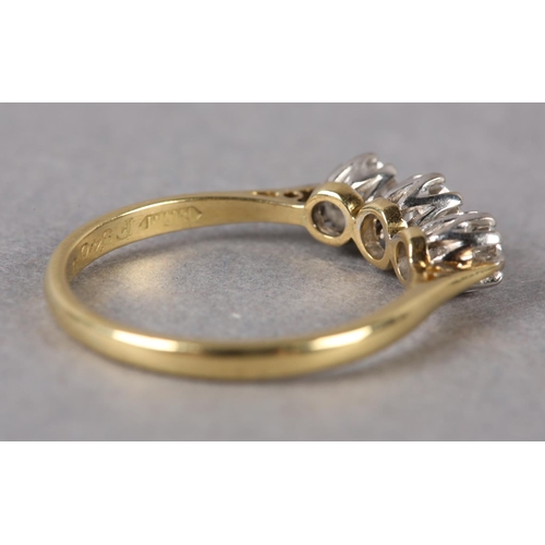 208 - A THREE STONE DIAMOND RING in 18ct yellow and white gold, the graduated brilliant cut stones claw se... 