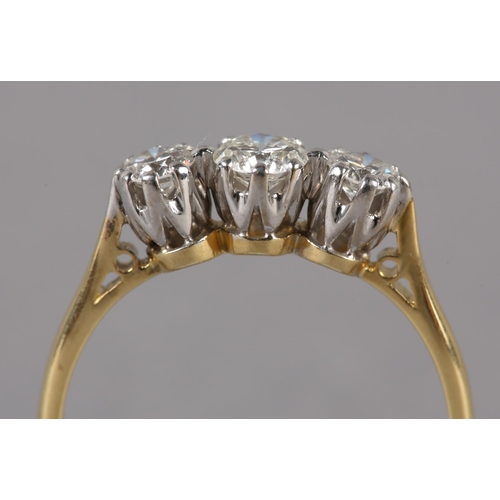 208 - A THREE STONE DIAMOND RING in 18ct yellow and white gold, the graduated brilliant cut stones claw se... 