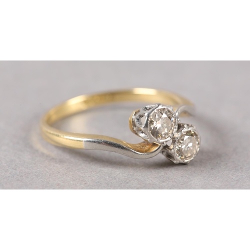 210 - A TWO STONE DIAMOND RING C1950 in 18ct gold and platinum, the brilliant cut stones illusion set in a... 