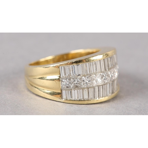 170 - A DIAMOND SET RING in 18ct gold, the graduated baguette and princess cut stones pave set flanked by ... 