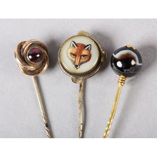 222 - A VICTORIAN REVERSE PAINTED FOX MASK STICK PIN IN ROLLED GOLD together with Victorian agate ball sti... 