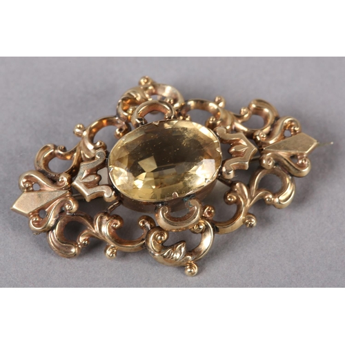 232 - A VICTORIAN CITRINE BROOCH in 9ct gold, collet set to the centre with an oval faceted citrine, raise... 