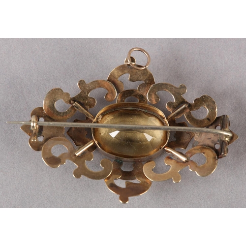 232 - A VICTORIAN CITRINE BROOCH in 9ct gold, collet set to the centre with an oval faceted citrine, raise... 