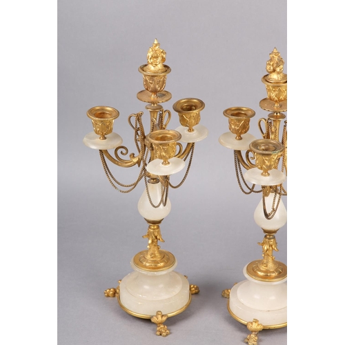 30 - PAIR OF GILT AND ALABASTER FOUR LIGHT CANDELABRAS, foliage sconces supported by scrolled arms with f... 